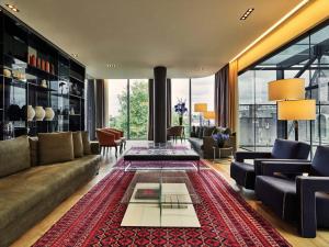 a living room with a couch and a table at Conservatorium Hotel in Amsterdam +37 photos