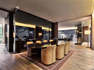 a dining room with a table and chairs at Conservatorium Hotel in Amsterdam