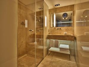 a bathroom with a shower and a sink at Conservatorium Hotel in Amsterdam