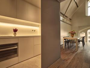 a kitchen with a table and a dining room at Conservatorium Hotel in Amsterdam
