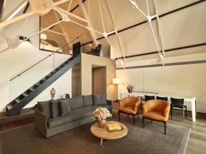 a living room with a couch and a table at Conservatorium Hotel in Amsterdam