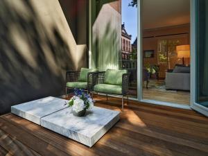 a living room with two chairs and a coffee table at Conservatorium Hotel in Amsterdam