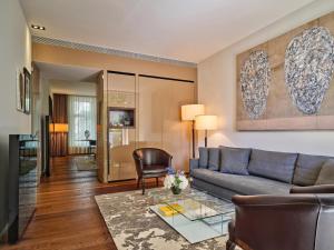 a living room with a couch and a table at Conservatorium Hotel in Amsterdam