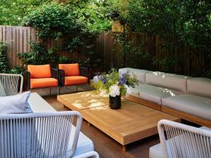 a patio with a couch and a table and chairs at Conservatorium Hotel in Amsterdam