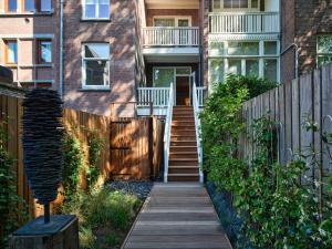 a house with a wooden walkway leading to the front door at Conservatorium Hotel in Amsterdam