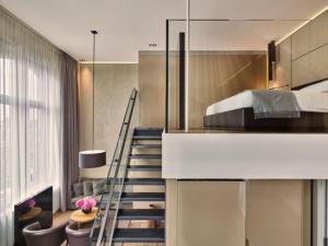 a room with a staircase leading to a bedroom at Conservatorium Hotel in Amsterdam