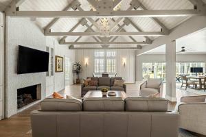 a living room with a couch and a fireplace at Lazy River Ranch - Lazy River Pool, Golf & Pickleball in Kreutzberg
