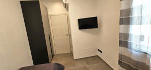 a hallway with a door and a television on a wall at Golden Moon in Lido di Ostia
