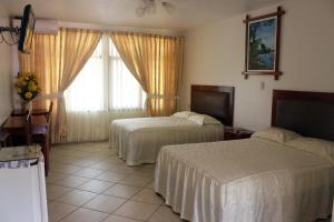 Voodi või voodid majutusasutuse Hotel Sol del Oriente Pucallpa toas