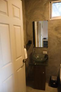 a bathroom with a sink and a mirror at Casa Nocodesa in Nicoya +24 photos