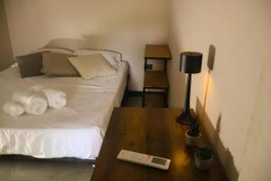 a bedroom with a bed and a table with a lamp at Casa Nocodesa in Nicoya