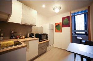 a small kitchen with a sink and a microwave at Home4U Κερατέα apt5, just 17Km from airport in Keratea