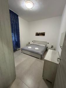a bedroom with a bed and a table in it at Giusi home in Cologno Monzese