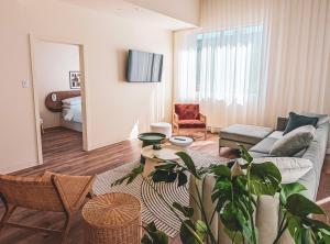 a living room with a couch and a table at Terminus Hôtel in Quebec City