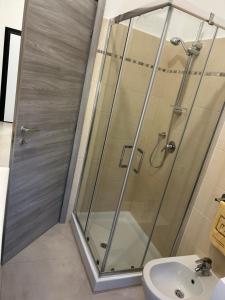 a shower stall in a bathroom with a sink at Giusi home in Cologno Monzese +16 photos