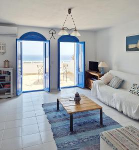 a living room with a couch and a coffee table at La Atalaya, Terraza con vistas al mediterráneo in Mojácar