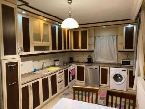 a kitchen with a sink and a washing machine at Alida Home Pamukkale in Pamukkale