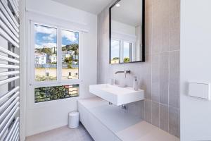 a bathroom with a sink and a window at New - sea view - splendid apartment in Nice +51 photos