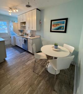 a kitchen and dining room with a table and chairs at Endless Beach #B,Oceanfront, 3bedrooms-2bath-Pet Friendly in Virginia Beach +14 photos