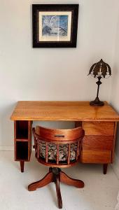 a wooden desk with a lamp and a chair at Casa Finchette rooftop apartment with panoramic views of Table Mountain in Cape Town