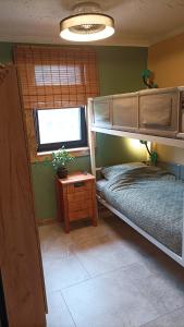 a bedroom with two bunk beds and a window at Holiday apartement Sentjur in Šentjur