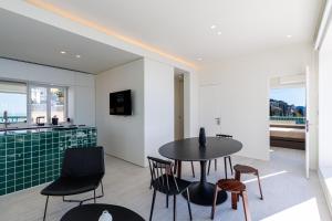a kitchen and dining room with a table and chairs at New - sea view - splendid apartment in Nice
