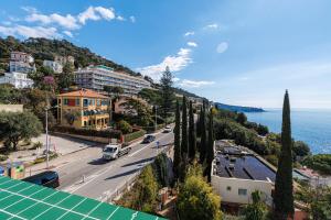 a view of a street with trees and the ocean at New - sea view - splendid apartment in Nice