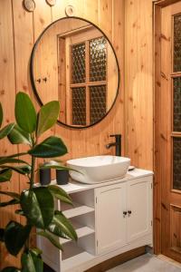 a bathroom with a sink and a mirror at Relaks w boberkach Prywatna sala do Bilarda in Bobrowiec +60 photos