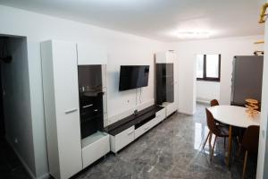 a living room with a tv and a table at Karla's House in Vaslui