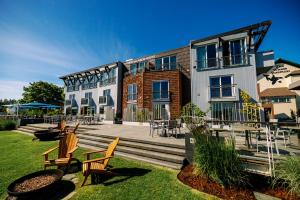 a building with chairs and tables in front of it at Friday Harbor House in Friday Harbor