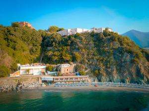 a resort on a hill next to the water at Hotiday Arenzano Pineta in Arenzano