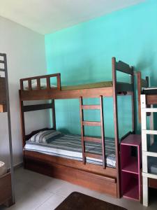 a bedroom with two bunk beds in a room at Hostel São Lourenço in Bertioga
