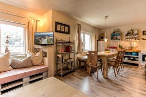 a living room with a table and a couch at Ferienhaus StrandHaus in Bad Schandau