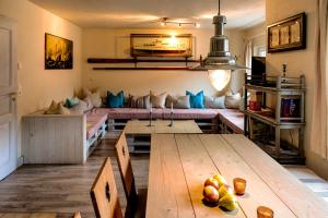 a living room with a table and a couch at Ferienhaus StrandHaus in Bad Schandau