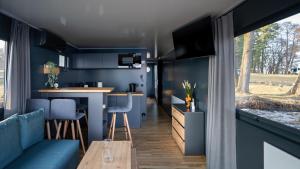 a kitchen and living room in a tiny house at Domek na wodzie - Marina & Camping Siemiany in Siemiany