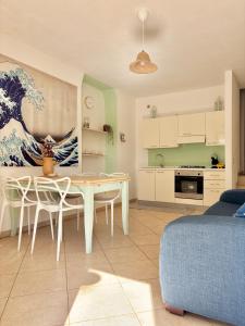 a kitchen and living room with a white table and chairs at La Dimora di Ulisse in Santa Cesarea Terme +78 photos