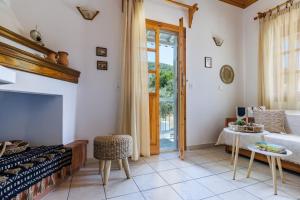 a living room with a fireplace and a bed and a table at Terpsis Origin Villa in Stafylos