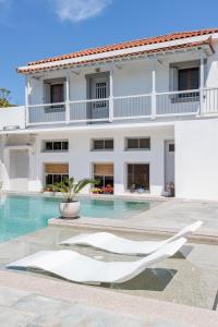a villa with a swimming pool and a building at Terpsis Origin Villa in Stafylos