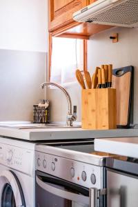 a kitchen with a washing machine and a knife block at Terpsis Origin Villa in Stafylos +16 photos