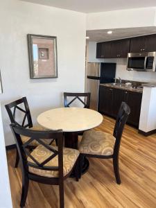 a kitchen with a table and chairs in a room at Flamingo Inn Beachfront - Daytona Beach in Daytona Beach