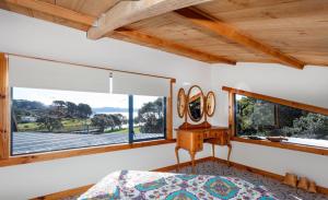 - une chambre avec un lit et une fenêtre dans l'établissement Reefers, à Kuaotunu
