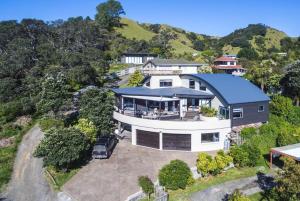 an aerial view of a large house with a driveway at Reefers in Kuaotunu