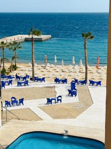 a view of a beach with chairs and the ocean at Juliana Beach Resort in Hurghada +40 photos
