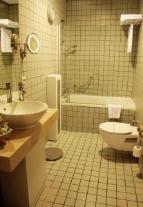 a bathroom with a sink and a toilet and a tub at MY Hotel in Izmir +34 photos