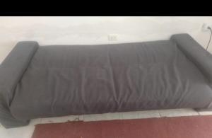 a bed frame in a room with avertisement for at Playa sol y arena in Puntarenas