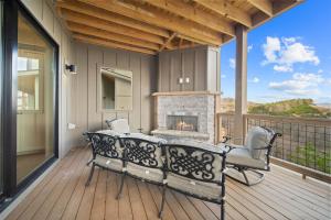 a screened porch with a fireplace on a deck at Happy Campers in Boone