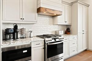 a kitchen with white cabinets and a stove top oven at Happy Campers in Boone +32 photos
