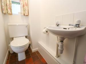 a bathroom with a toilet and a sink at Sea Star in Porthleven