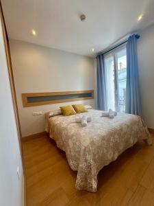 a bedroom with a bed with two towels on it at Alcazar Suites in Jerez de la Frontera +46 photos