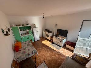 a kitchen with a green refrigerator and a table at Bodenik in Bileća